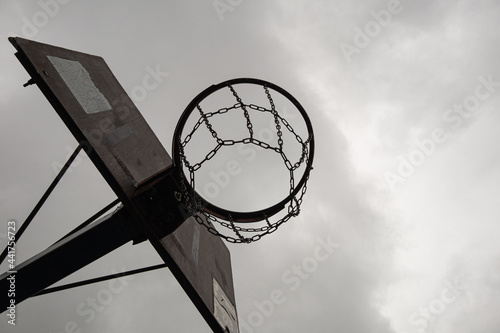 street basketball hoop with metal chain basketball net on dramatic sky background