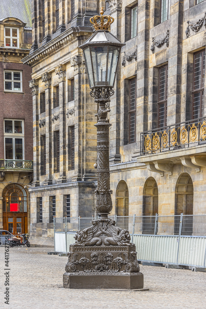 Antique Lamp Post near Royal Palace (Koninklijk Paleis) at the Dam Square in Amsterdam, The Netherlands.