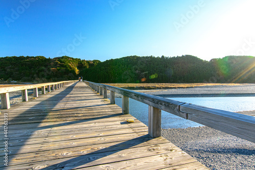 wooden bridge over the river © worm_ flag