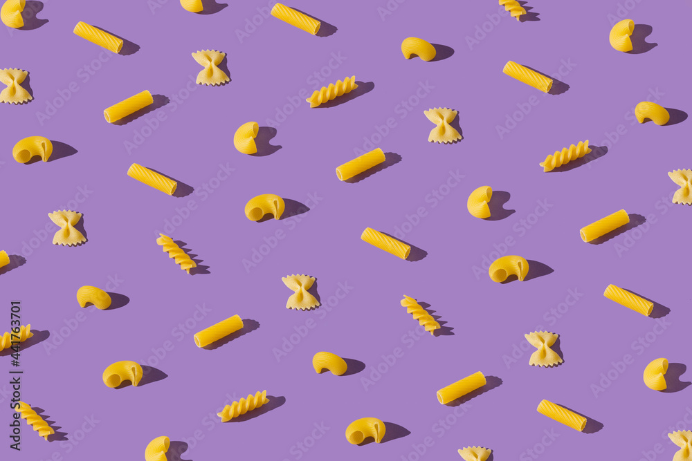 Flat lay pattern with different shapes of pasta. Minimal food composition. Creative macaroni pattern. Flat lay pattern with different shapes of pasta. Minimal food composition. Creative macaroni pattern.