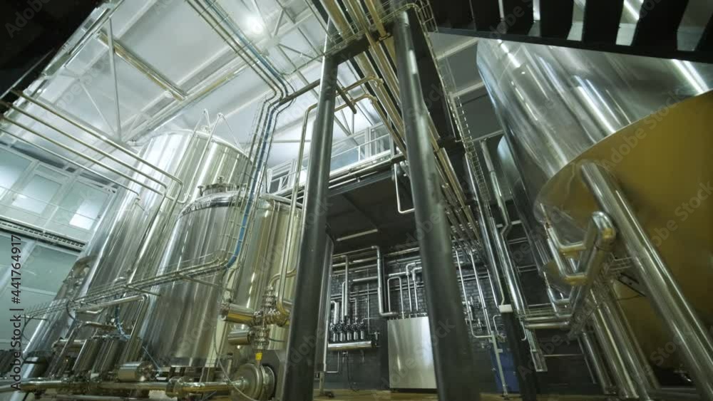 Modern craft brewery. Craft beer production. Modern equipment in brewery, metal tanks, alcoholic drink production Modern craft brewery. Craft beer production. Modern equipment in brewery, metal tanks, alcoholic drink production