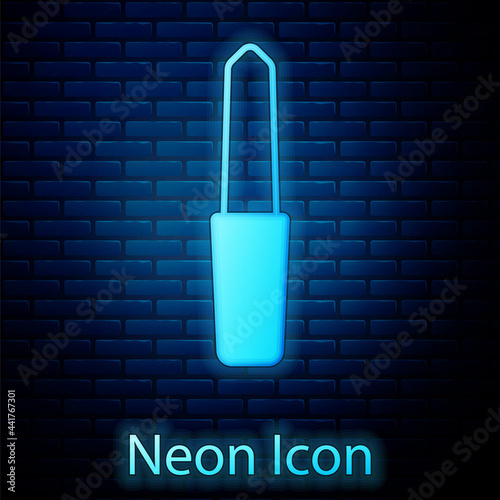 Glowing neon Nail file icon isolated on brick wall background. Manicure tool. Vector