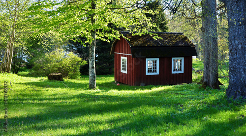 Red old playhouse in the garden