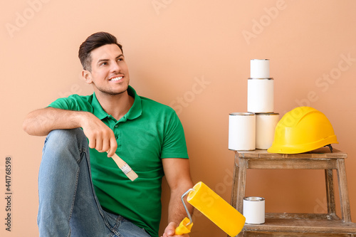 Young man with roller, brus...