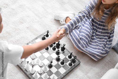 Cute children playing chess...