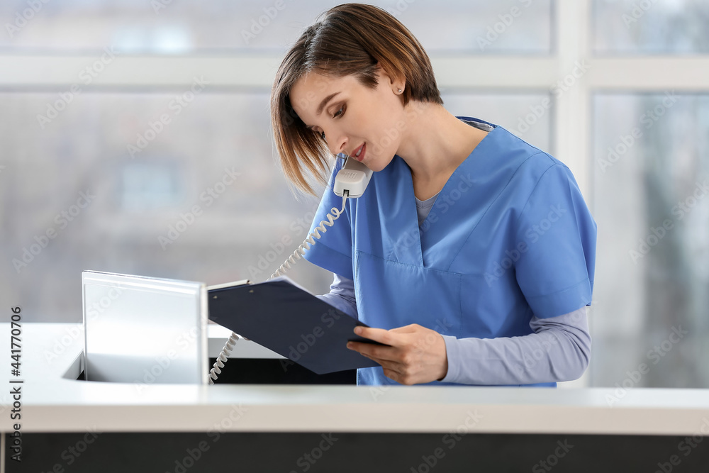 Female receptionist working in clinic Female receptionist working in clinic
