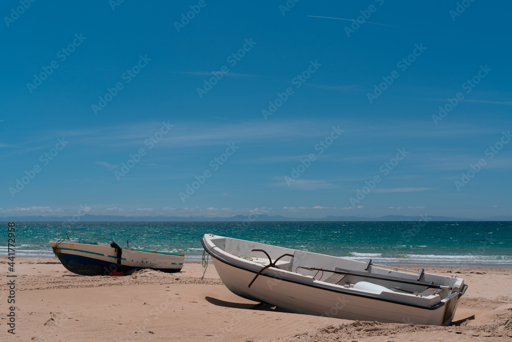two boats seascape at bolonia dunes in Cadiz, Andalucia