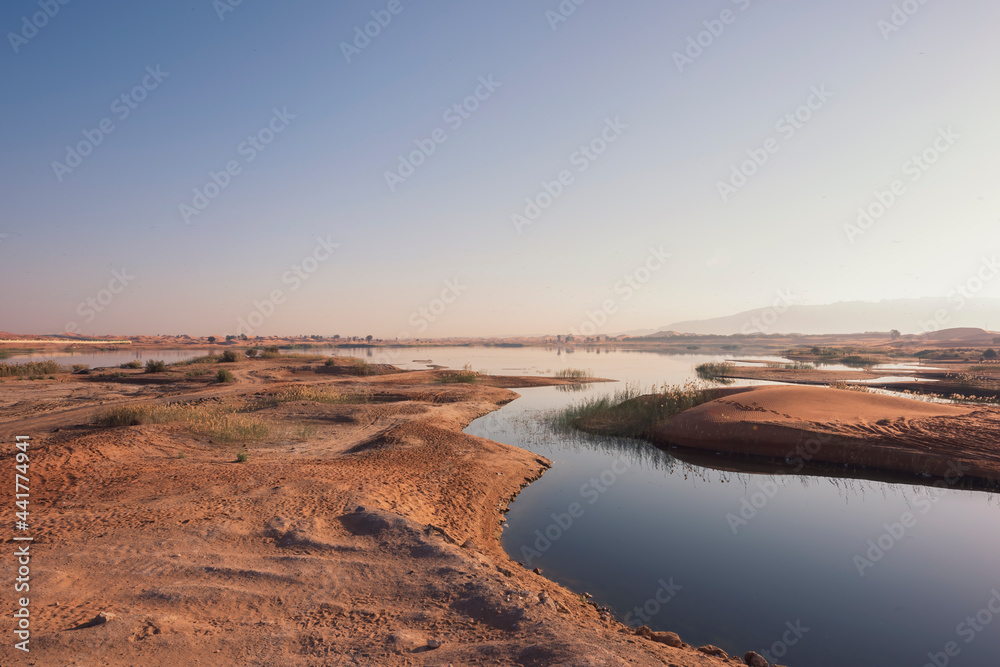 Desert camp setting place with water spots and mountain. Desert camp setting place with water spots and mountain.