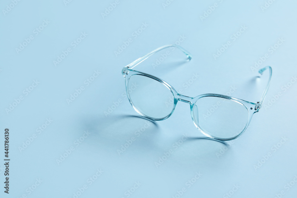 Stylish eyeglasses on color background Stylish eyeglasses on color background