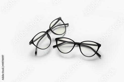 Different stylish eyeglasses on white background