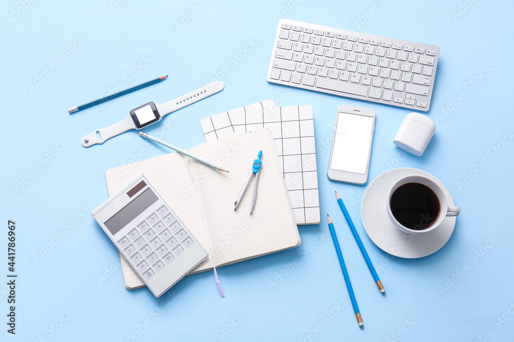 Different office tools, cup of coffee and devices on color table Different office tools, cup of coffee and devices on color table