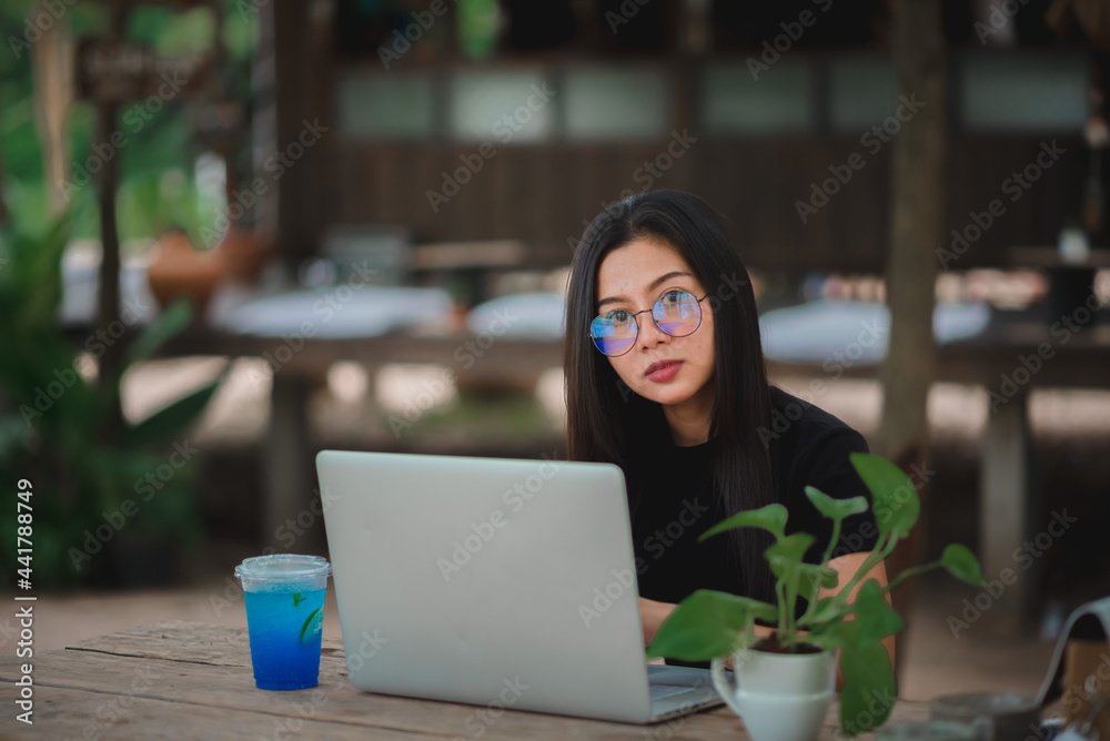 young woman sitting at home working on a laptop computer young woman sitting at home working on a laptop computer