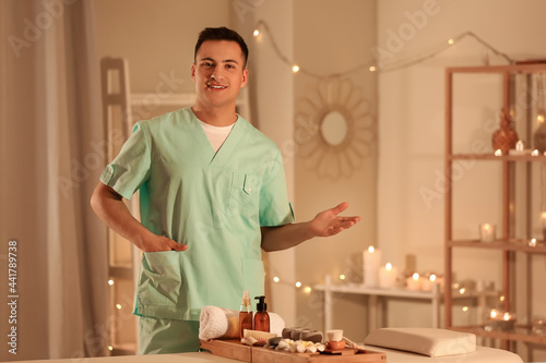 Male massage therapist in spa salon