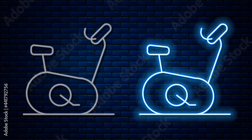 Glowing neon line Stationary bicycle icon isolated on brick wall background. Exercise bike. Vector