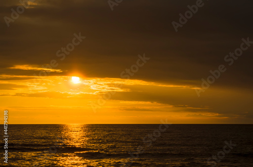 Beautiful summer sunset over the baltic sea. The sun's rays pass through the clouds