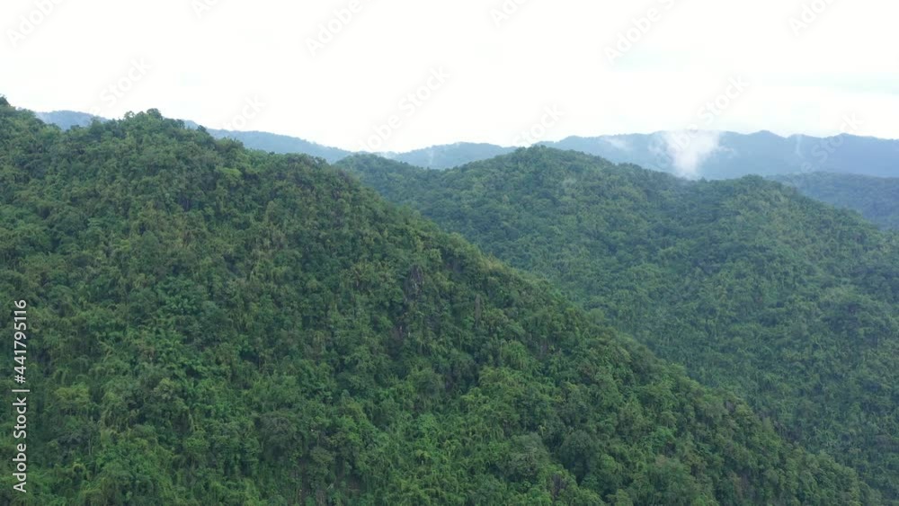 Aerial view flying above lush green tropical rain forest mountain with rain cloud cover during the rainy season on the Doi Phuka Mountain reserve national park. In, the northern Thailand Aerial view flying above lush green tropical rain forest mountain with rain cloud cover during the rainy season on the Doi Phuka Mountain reserve national park. In, the northern Thailand
