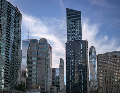 Cluster of new skyscrapers in Downtown Toronto on a blue and cloudy sky background © redfoxca