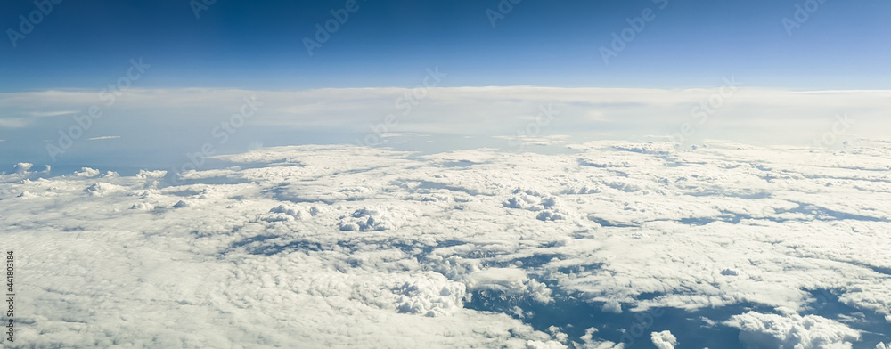 Clouds and mountain peaks.
Wallpaper of clouds and mountain peaks from the height of an airplane, side view close-up