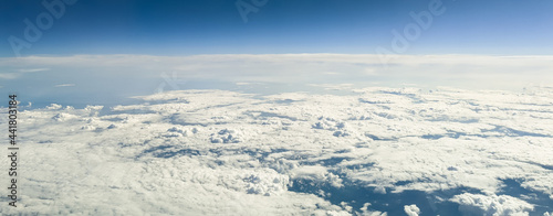 Clouds and mountain peaks. Wallpaper of clouds and mountain peaks from the height of an airplane, side view close-up