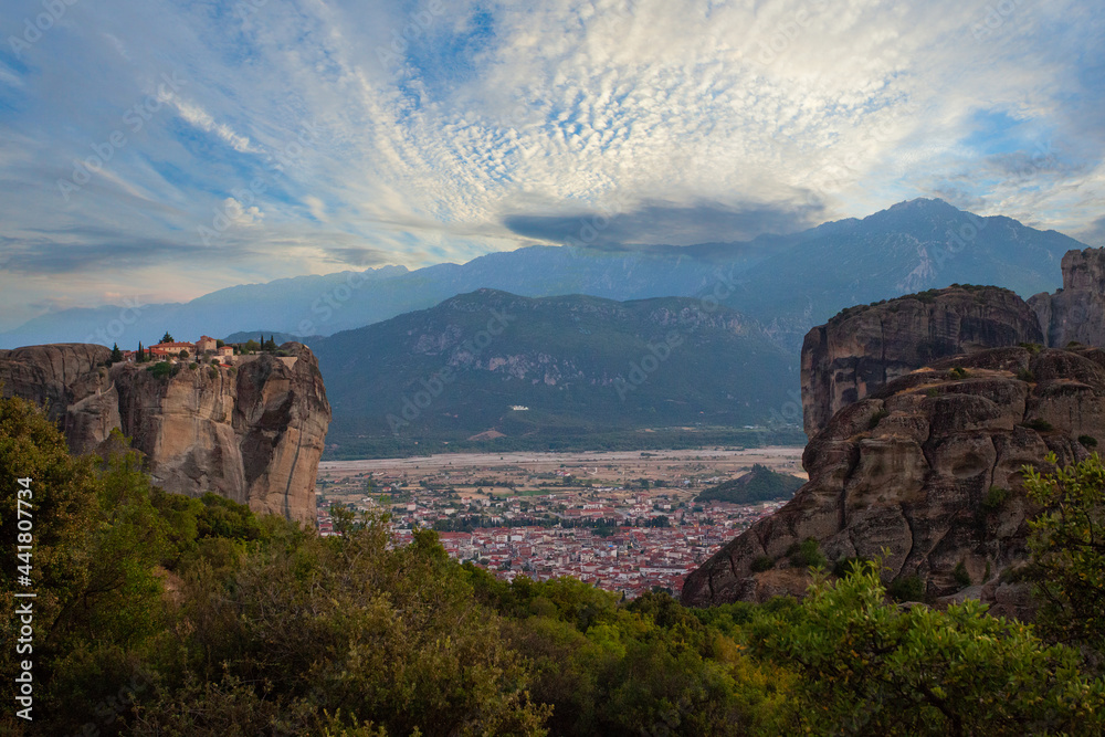 Blue sky and white clouds against monastery and town Kalambaka Meteora Greece