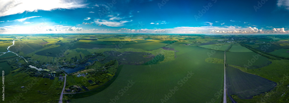 small village Kalikino (Tambov region, Russia) surrounded by green fields, as well as the regional center Tokarevka and its surroundings - a large panorama view from a height on a sunny day