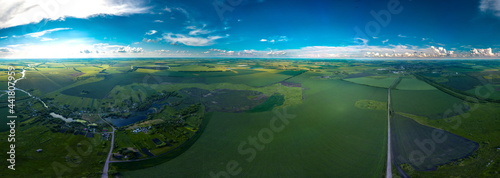 small village Kalikino (Tambov region, Russia) surrounded by green fields, as well as the regional center Tokarevka and its surroundings - a large panorama view from a height on a sunny day © Alexei Merinov