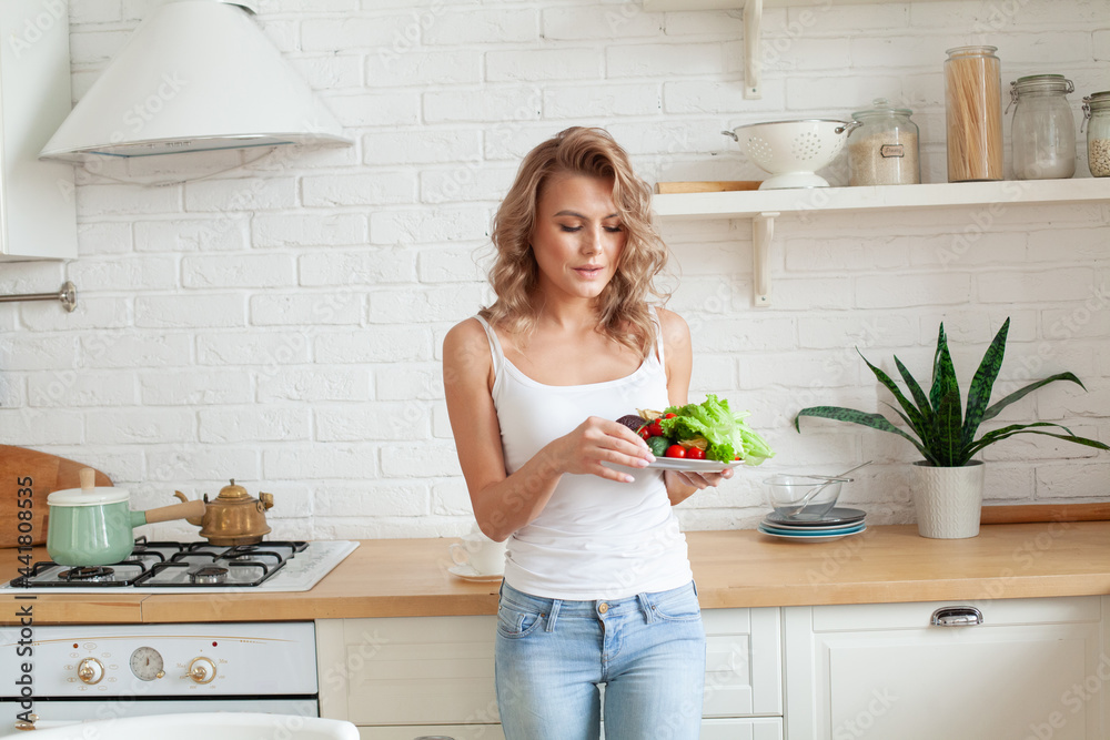 Fit woman eating healthy vegetable Fit woman eating healthy vegetable