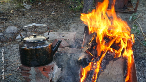 outdoor recreation in the forest by the campfire black kettle bonfire burning wood fire forest camping