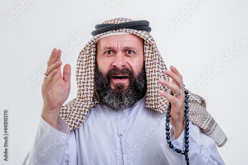 Surprised Arabic man posing on wwhite background photo