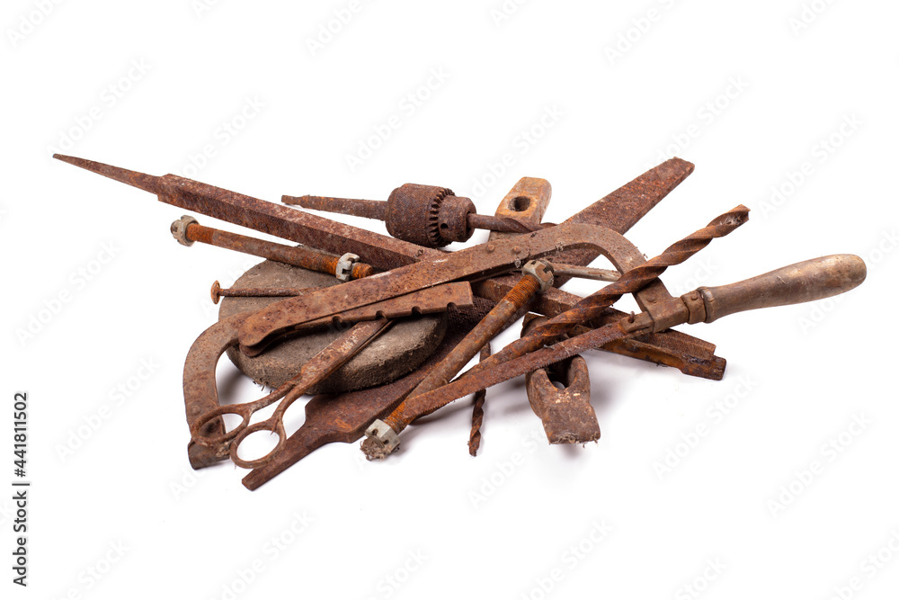 Rusty old antique iron tools, scrap metal on white background. Rust metal surface. Rusty old antique iron tools, scrap metal on white background. Rust metal surface.
