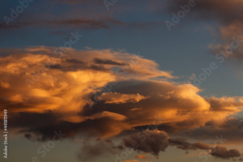 Dramatic sunset sky. Magical view of the dusk red, orange and yellow colors in the clouds and sky.