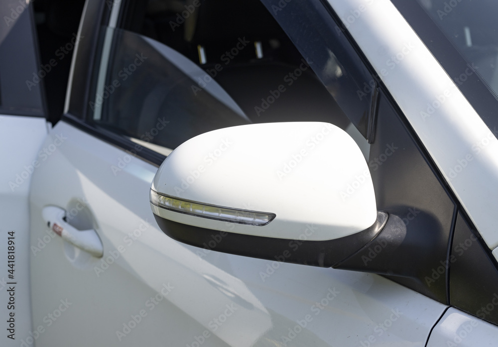 side rearview mirror of a white car with duplicate turning elements side rearview mirror of a white car with duplicate turning elements