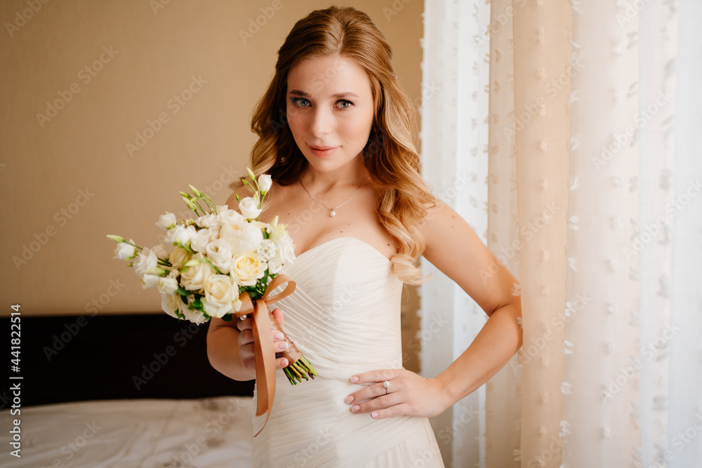 portrait of a beautiful bride with a bouquet by the window. Wedding traditions. portrait of a beautiful bride with a bouquet by the window. Wedding traditions.
