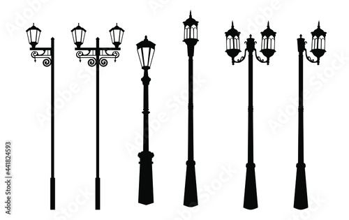 A set of vintage street lights. Silhouette of a street lamp, a lantern with a forged lattice, black and white color, isolated on a white background