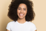 Profile picture of smiling millennial African American woman isolated on yellow background show healthy white teeth. Headshot portrait of happy young biracial female excited with dental treatment.