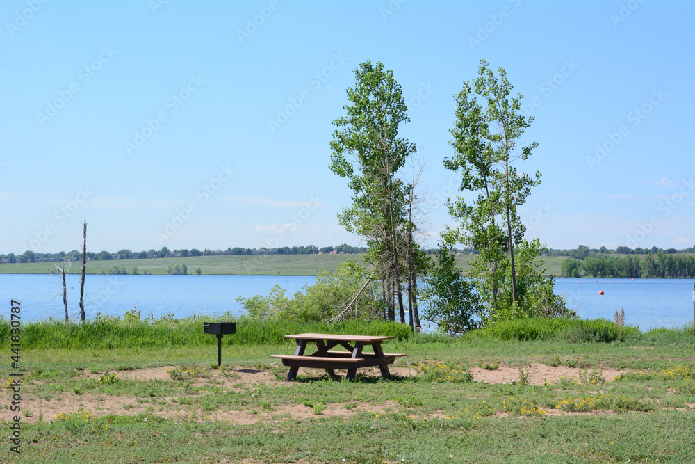 Summertime Standley Lake in Westminster Colorado Landscape with picnic table and outdoor grill with high water level Summertime Standley Lake in Westminster Colorado Landscape with picnic table and outdoor grill with high water level