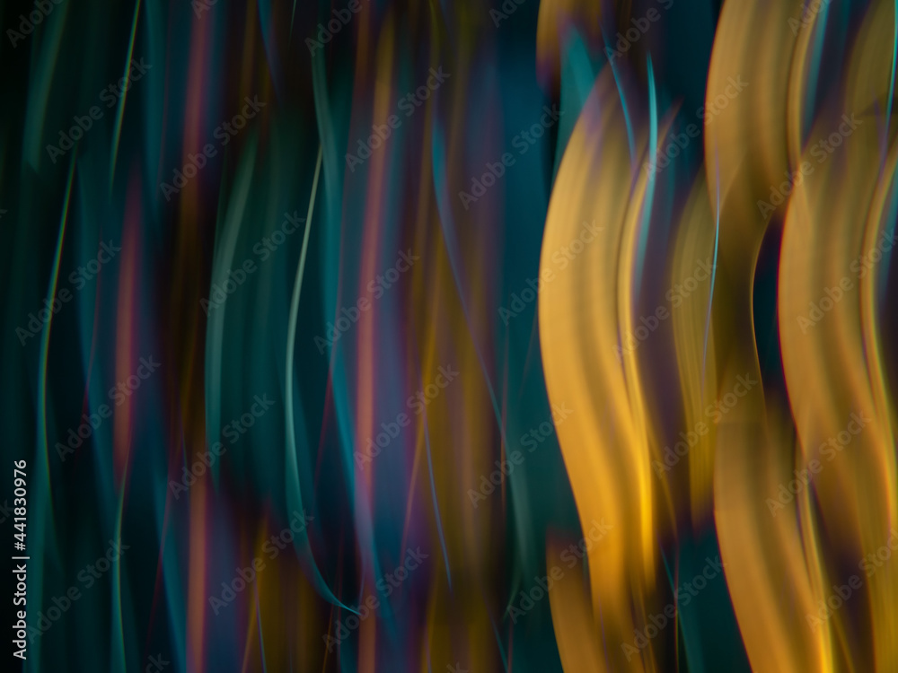 Fototapeta premium light painting photography, waves of vibrant color against a black background. Long exposure photo of vibrant fairy lights in abstract 