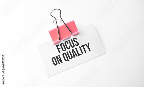 Finance and business concept. On a white background is a marker and a business card with the inscription - Focus on Quality