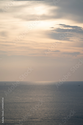 Fototapeta Naklejka Na Ścianę i Meble -  Twilight Golden time in the sea view of Phrom Thep Cape, the tropical sea sunset period, scenic point of Phuket Island, The Pearl of the Andaman Sea,Thailand popular for tourist in the world.