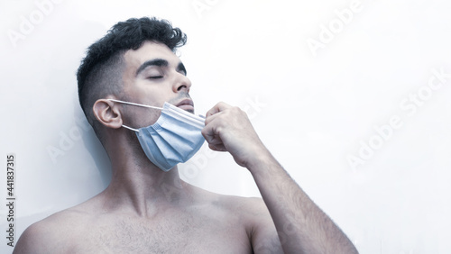 young man finally removing his mask.
free covid photo