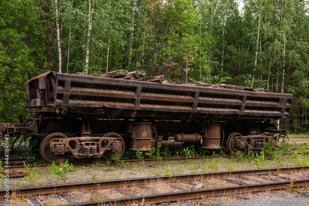 an abandoned Russian car on the rails in the forest an abandoned Russian car on the rails in the forest