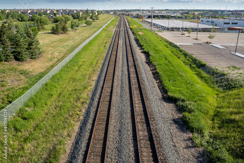 Aerial photograph of a pair of train tracks leading into Airdrie Alberta Canada.