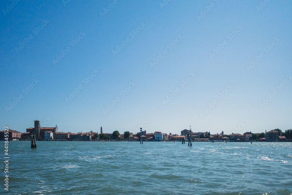 Island and lagoon under blue sky in Venice, Italy