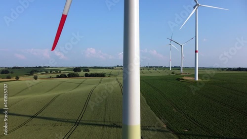 Energy transition: Renewable energies from wind power. Wind turbines in an agricultural field on a summer afternoon.