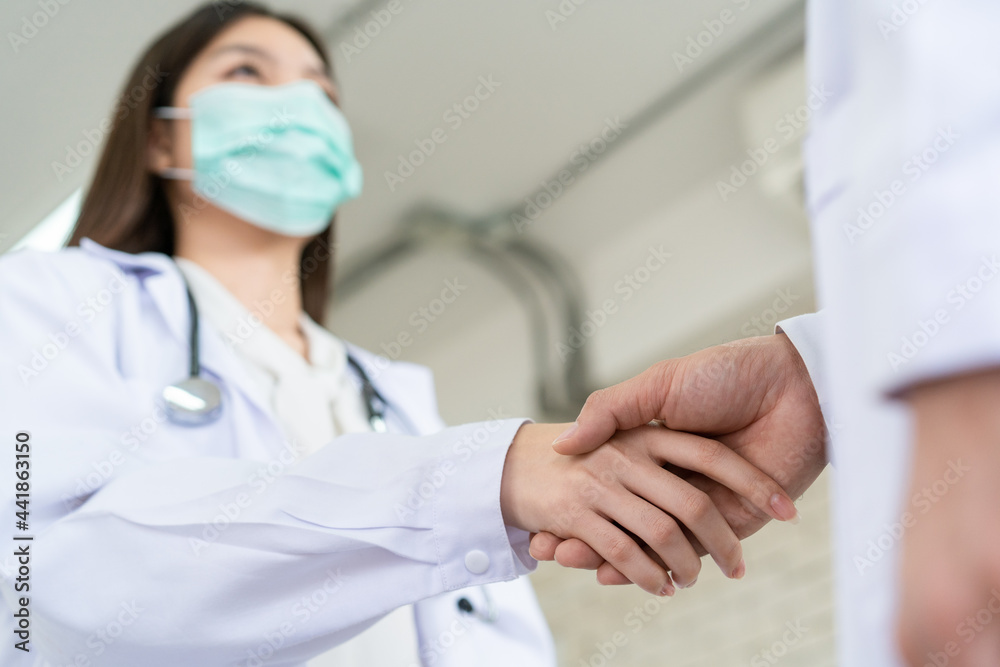 Two senior specialist doctor making a handshake together. Two senior specialist doctor making a handshake together.