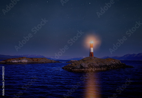 Argentina, Patagonia, Ushuaia, Beagle Channel, Illuminated lighthouse on rocky islet at night