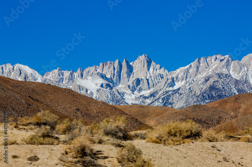 USA, California, Lone Pine, Snowcapped Mount Whitney with rocky hills in foreground