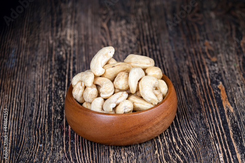 pile of cashew nuts on the table and in a wooden plate while eating