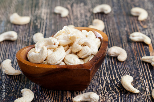 close-up of peeled cashews on the kitchen table in a wooden plate