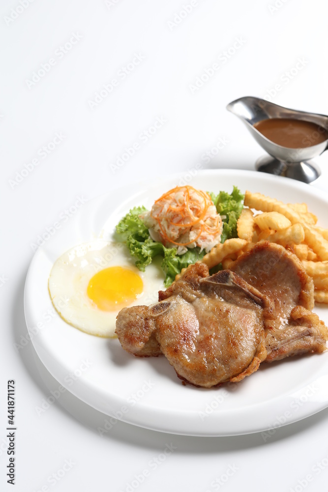 grilled golden bbq meat chicken cop pork cutlet beef steak with fried egg, French fries, coleslaw salad and black pepper sauce in pot western cuisine menu grilled golden bbq meat chicken cop pork cutlet beef steak with fried egg, French fries, coleslaw salad and black pepper sauce in pot western cuisine menu